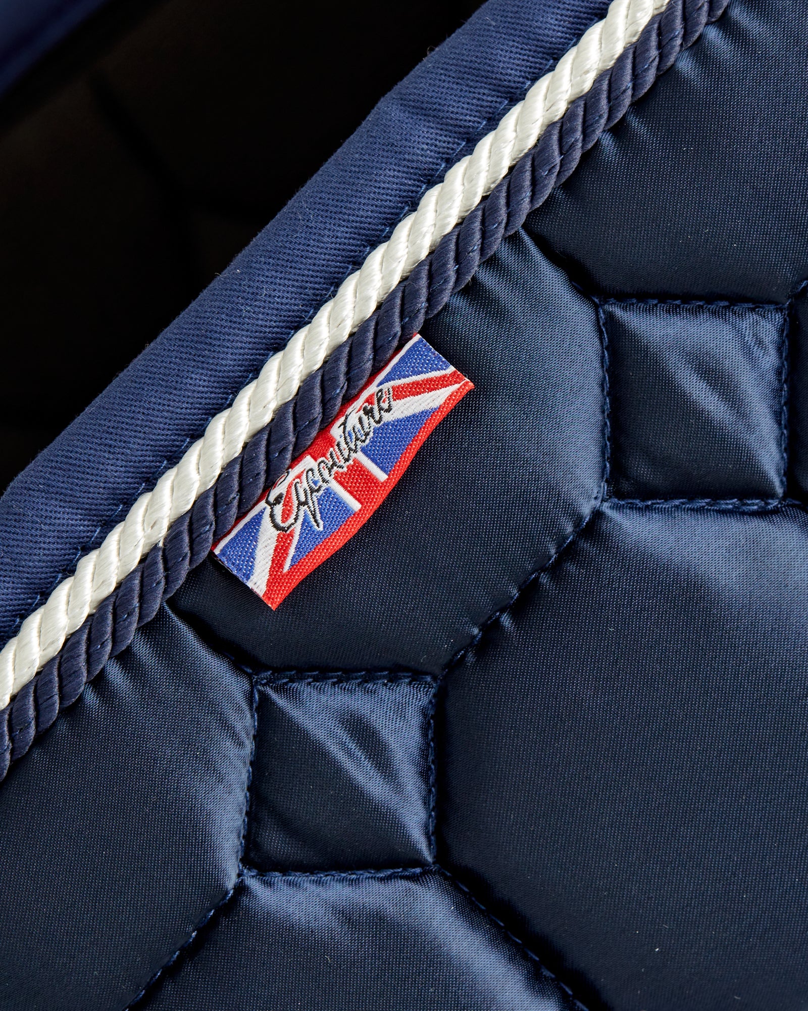 Equestrian luxury quilted navy satin jumping cut saddle pads/numnahs.