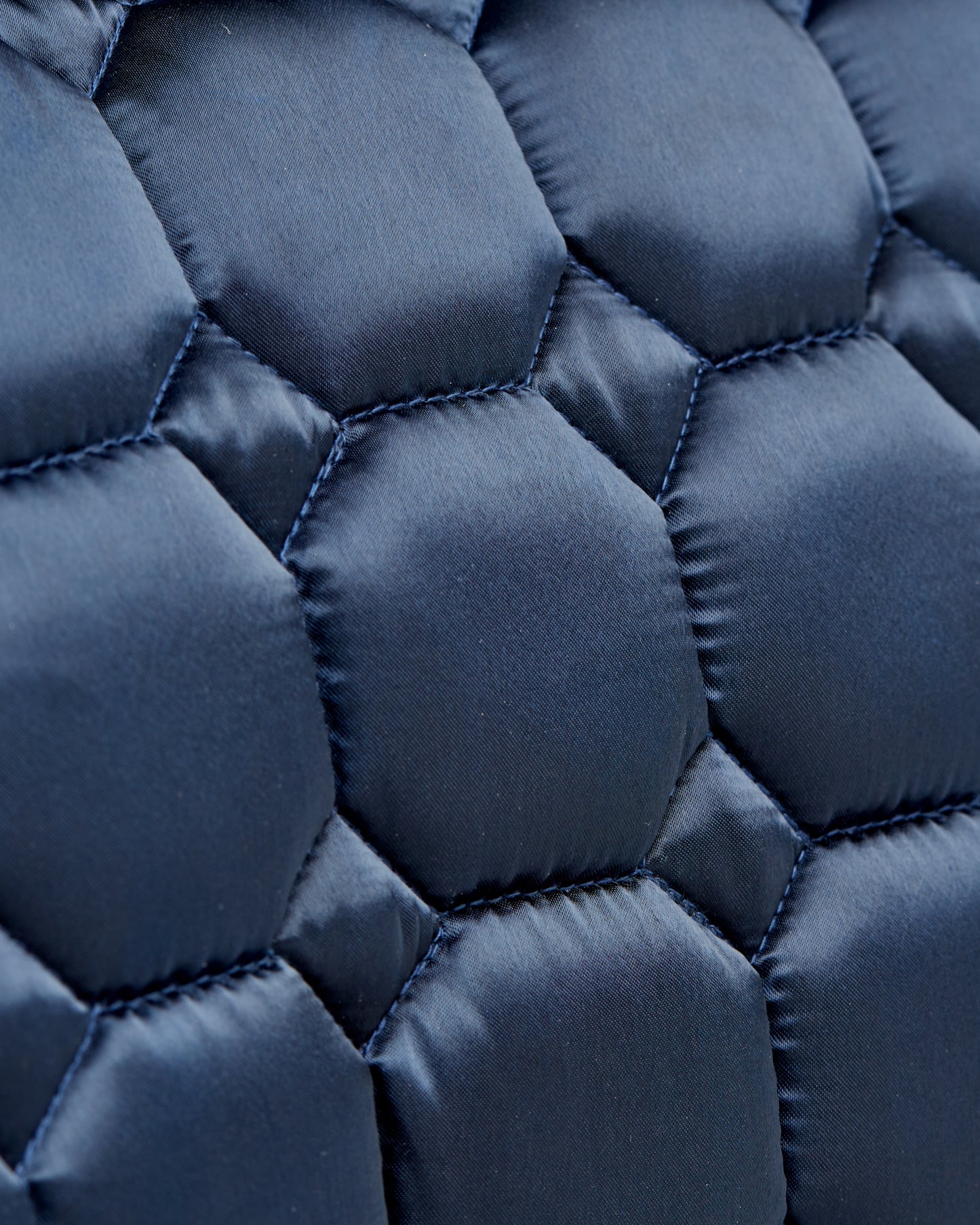 Equestrian luxury quilted navy satin jumping cut saddle pads/numnahs.
