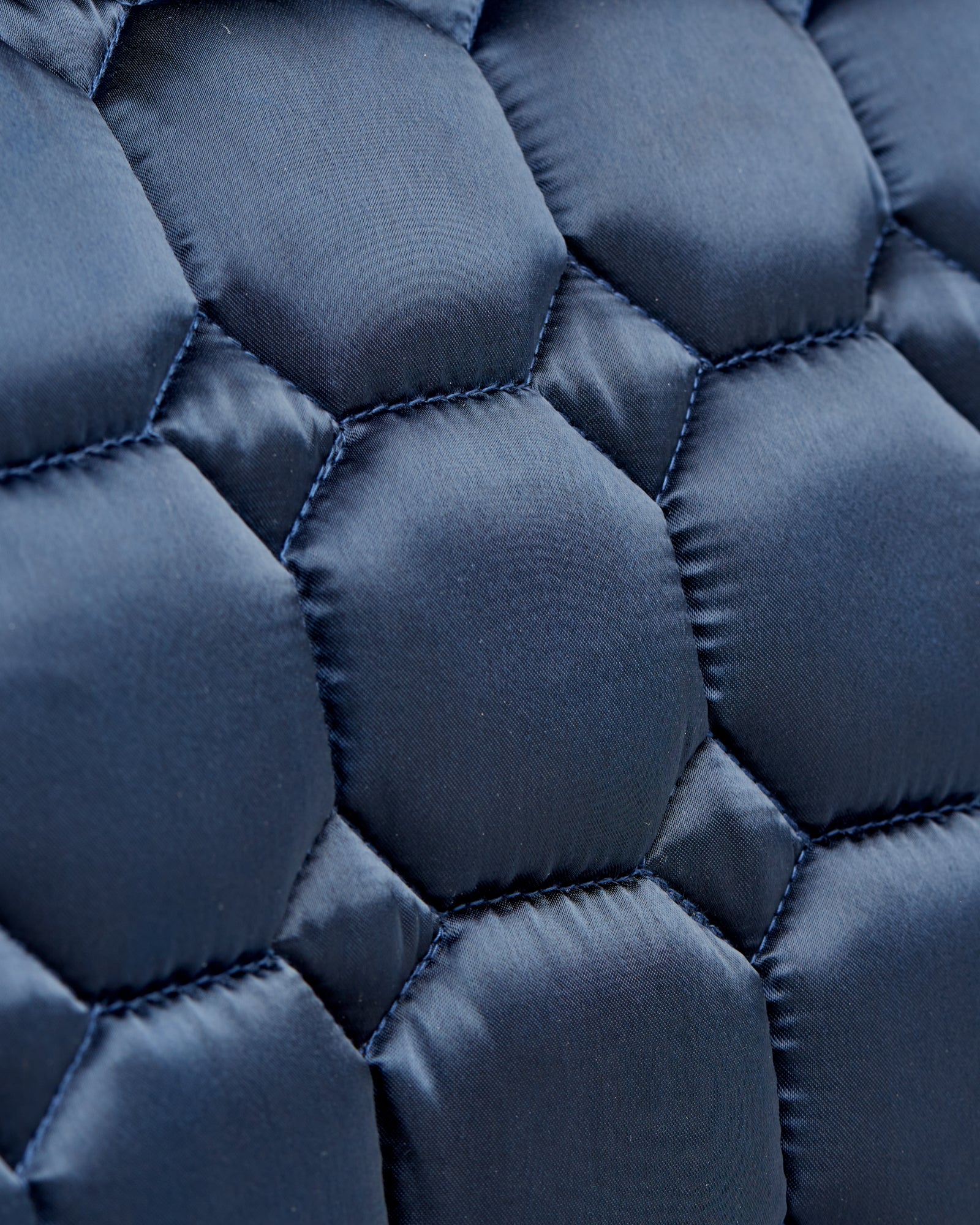 Equestrian luxury quilted navy satin jumping cut saddle pads/numnahs.