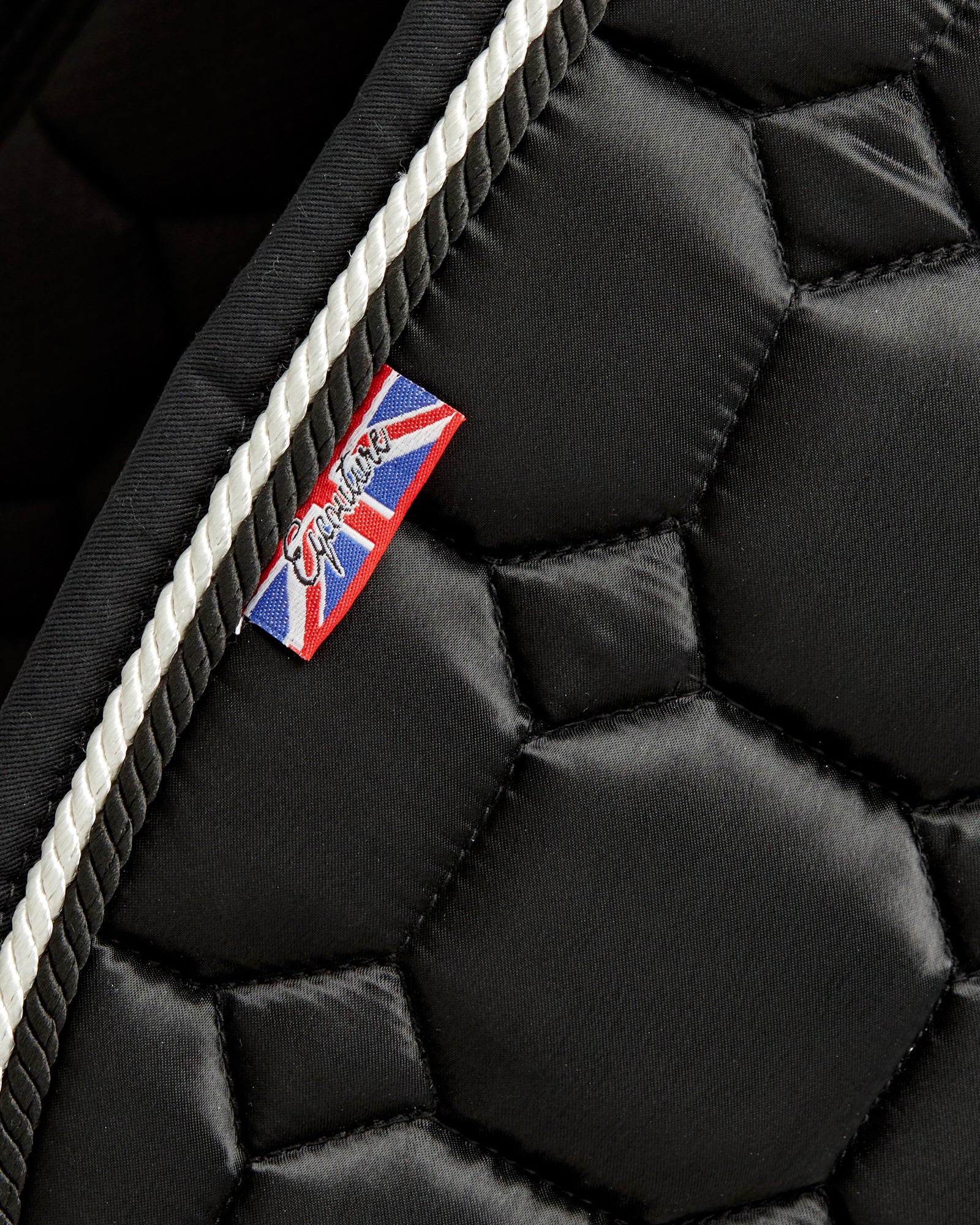 Equestrian luxury quilted black satin jumping cut saddle pads/numnahs.